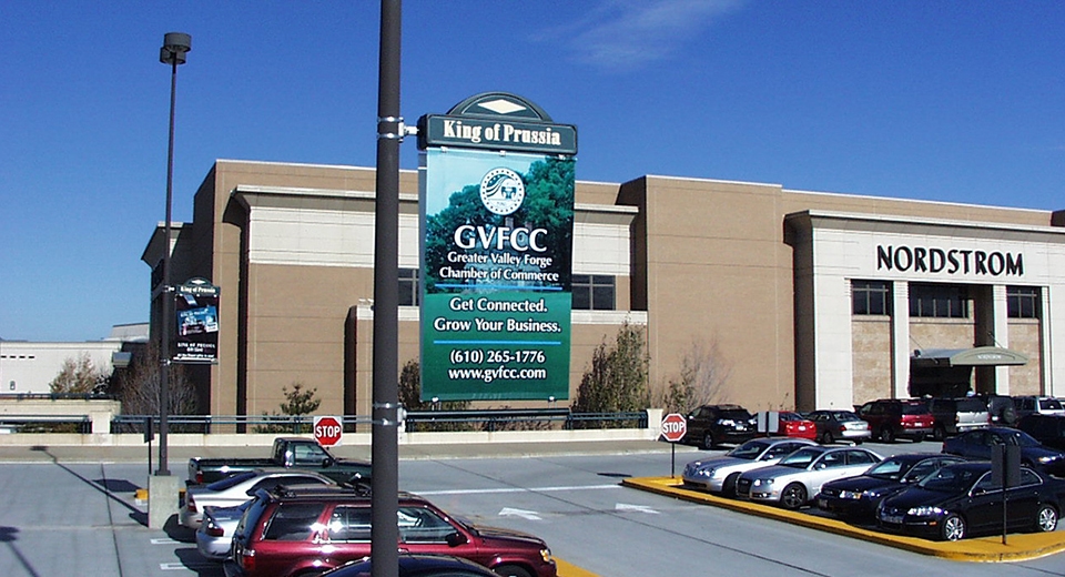 Image of a Lumen Banner displaying an advertisement for the Greater Valley Forge Chamber of Commerce in a parking lot that is easy to read during the day.