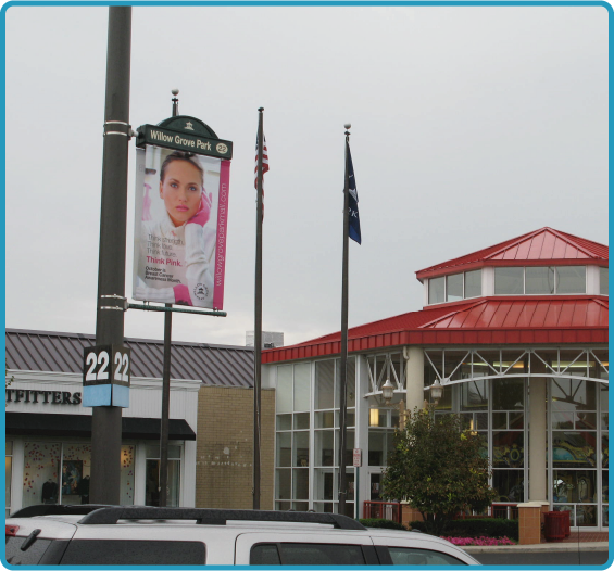 Lumen Banner displaying an advertisement in the Willow Grove Park mall parking lot.